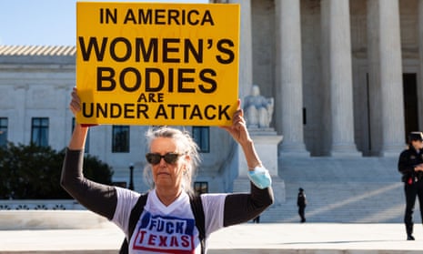 A protester holds a sign in front of the supreme court in Washington. 