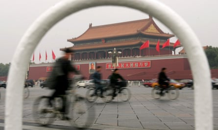 Chinese cyclists pedal past the Forbidden City in Beijing.