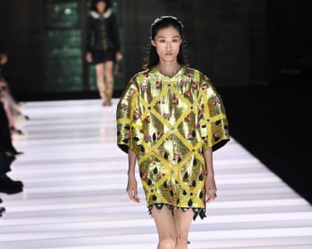 Model wears jewelled yellow tunic dress