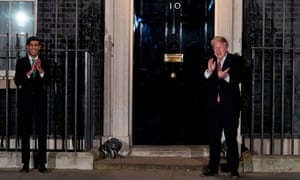 Boris Johnson (R) and Rishi Sunak clap in appreciation of NHS workers.