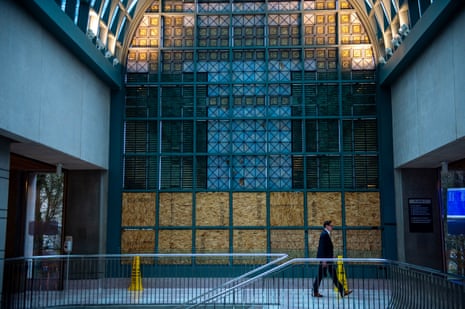 A man walks inside a grand building under renovation