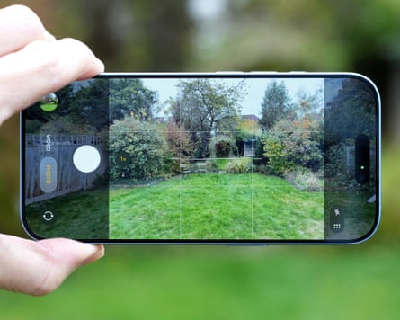 The camera app on the iPhone 17 taking a picture of a garden scene.