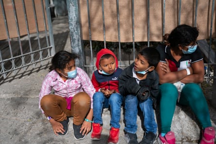 Four children sit on the streets of Ciudad Juárez after being deported from the US.