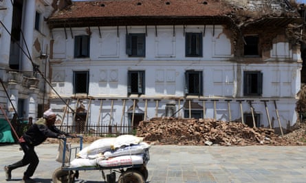 A Nepalese porter pushes a cart through Basantapur Durbar Square two years after the earthquake.