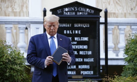 Donald Trump examines a Bible during a photo opportunity outside St John’s church in Washington on 1 June 2020.