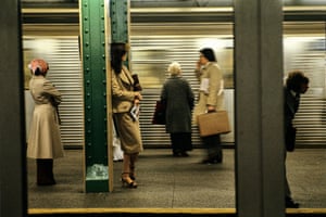 a Willy Spiller photo titled "Getting To The Office, Grand Central Station, 1983" - people stand on a subway platform minding their own business as a train hurtles past in a blur in the background