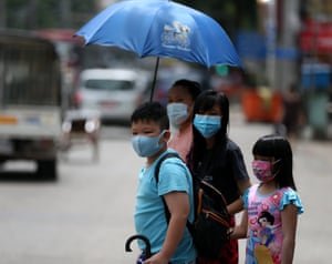 People wearing masks walk in downtown Yangon, Myanmar after 70 more Covid-19 cases were confirmed on Wednesday morning, the highest surge in a single day since the disease was first detected in the country.