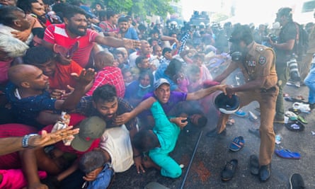Police fire teargas to disperse supporters of the opposition National Peoples Power (NPP) party during a protest to urge the government to hold local council elections as scheduled in Colombo in February last year