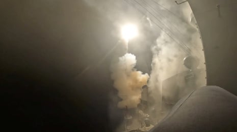 A missile being launched into the air in the dark.