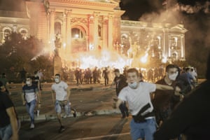 Protesters run away from advancing riot police.