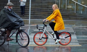 Helen Pidd riding a Mobike in rainy Manchester. 