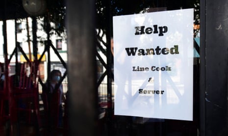 A ‘help wanted’ sign posted at restaurant looking for line cooks and servers in Los Angeles, California.