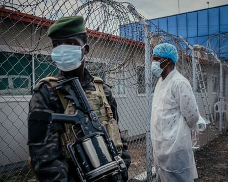 A soldier and a health worker at a lab that tests suspected Ebola cases in the Democratic Republic of the Congo
