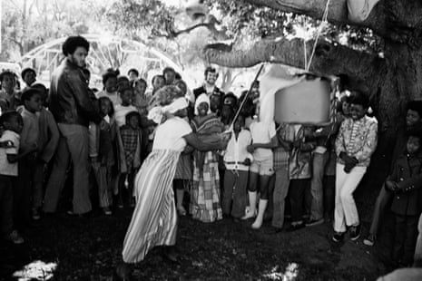 Children scramble for candy after a pig piñata was broken open during a Free Bobby rally in Defermery Park.