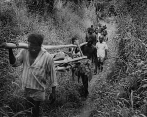 Carrying a wounded BRA guerilla, hit by mortar shrapnel, near Durainer, Bougainville, 1994.