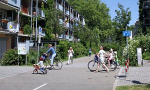 Housing and cyclists in the green suburb of Vauban, Freiburg, Germany.