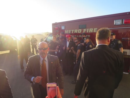 Trump poses with fire-fighters after the rally