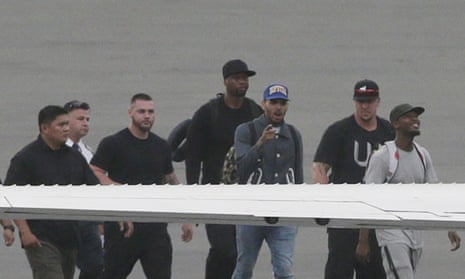 Chris Brown (third from right) walks to board a chartered jet at Manila domestic airport.