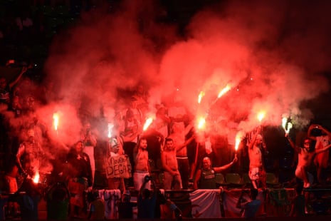 Algeria supporters light flares.
