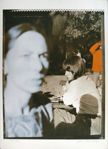 a woman looking ahead as another woman sits outside behind her