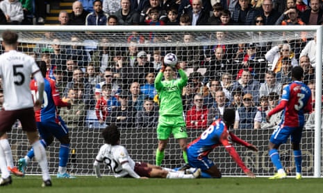 Crystal Palace's keeper Dean Henderson saves from Manchester City's Rico Lewis.