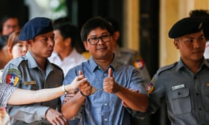 Reuters journalist Wa Lone is escorted to court in Yangon