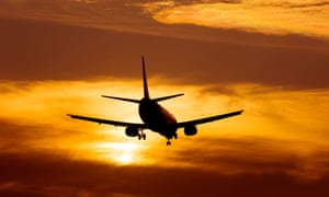Aeroplane landing at sunset