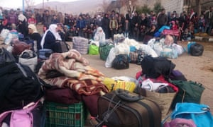 Syrians wait for the arrival of an aid convoy in the besieged town of Madaya.