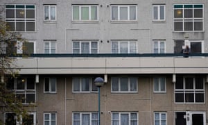A man looks out on the Broadwater Farm housing estate in Haringey, north London.