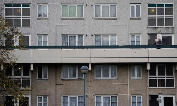 Man looking over balcony on Broadwater Farm estate in Haringey.