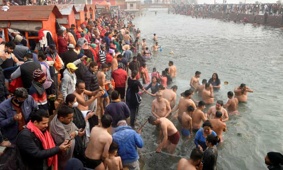 Hindu devotees take a dip in the Ganges on the first day of Kumbh Mela
