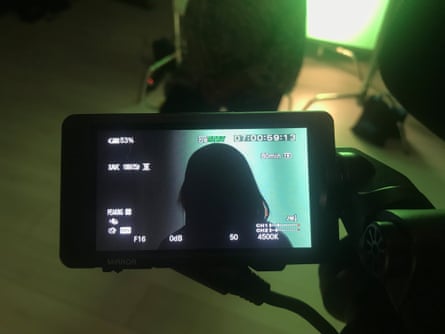 Silhouette of a woman in a video camera viewfinder