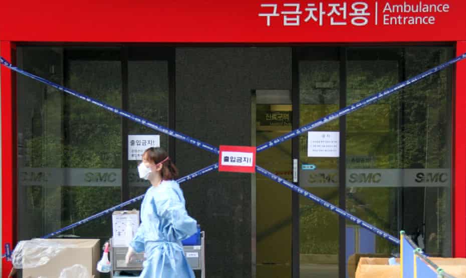 A medical worker walks past a hospital in Seoul where patients with Mers are being treated.