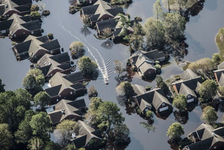A boat passes through a flooded neighborhood in this aerial photograph taken above Wallace, North Carolina.