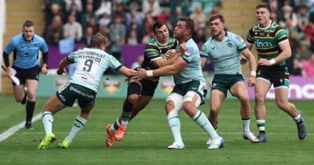 Northampton’s Edoardo Todaro is held by Leicester players.