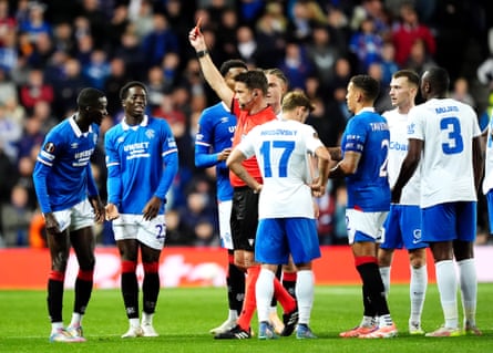 Rangers’ Mohammed Diomande (left) is shown a red card by referee Matej Jug