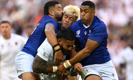 Manu Tuilagi of England is tackled by Duncan Paia'aua, Jonathan Taumateine and Nigel Ah-Wong of Samoa.
