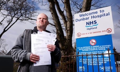 Peter Todd holding freedom of information documents outside NHS Dunbar hospital