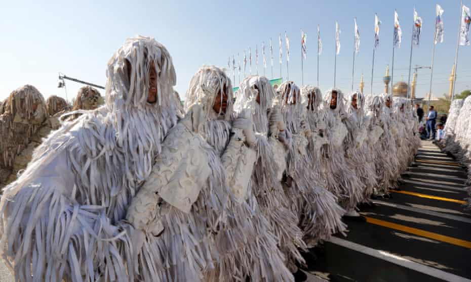 Camouflaged Iranian Army soldiers march during a parade in Tehran.