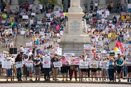 People with signs such as ‘say no to Nazis’, ‘where is the humanity?’ and ‘we the people say.. hands off democracy resist!!’