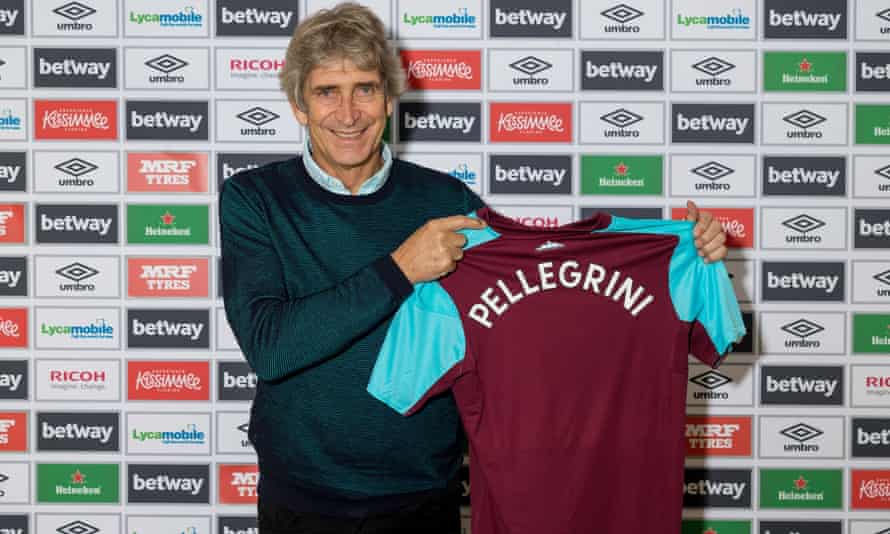 Manuel Pellegrini poses with a West Ham shirt.