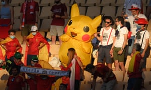 Some of the Spanish fans enjoy the sunshine in the stadium.