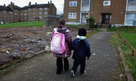 Children make their way home from school on a housing estate in Glasgow.