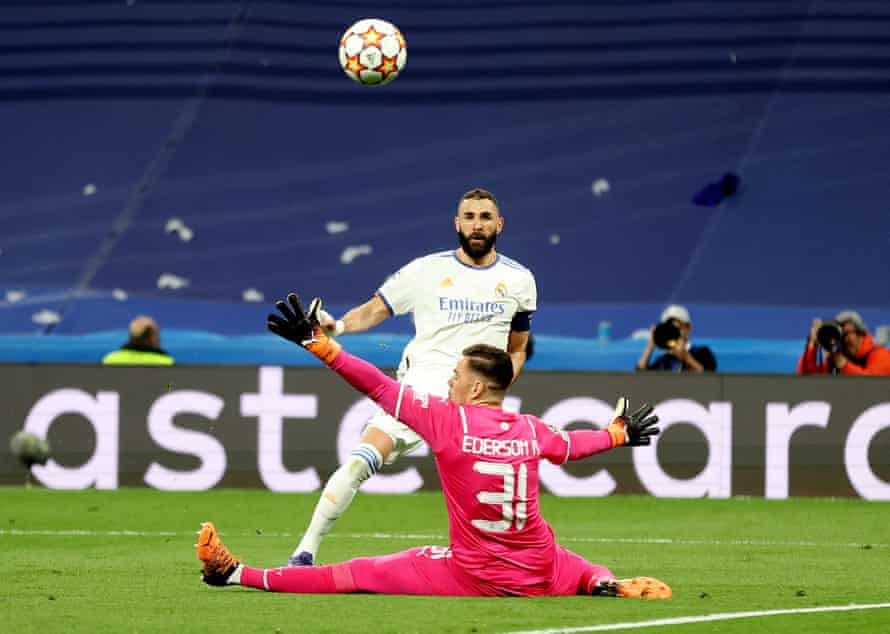 Real Madrid’s Karim Benzema shoots past Manchester City’s keeper Ederson but also over the bar.