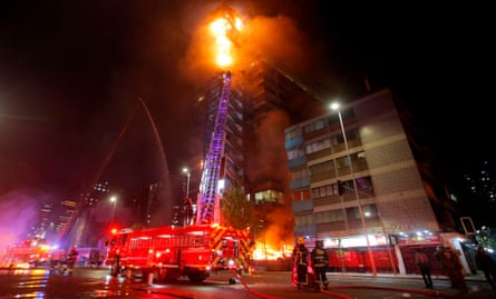 Flames engulf the iconic Enel building in downtown Santiago on Friday.