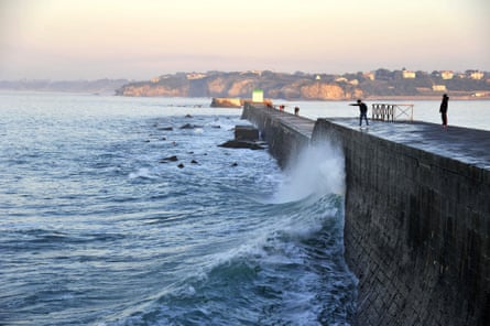 A harbour wall with waves crashing against it