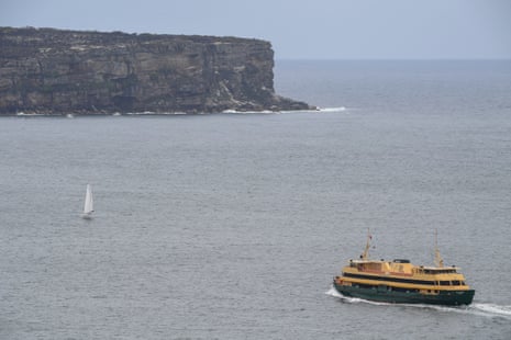 A Manly ferry crosses in front of North Head