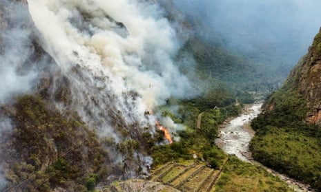 The forest fire burning near Machu Picchu, Peru, as emergency personnel continued to fight the blaze