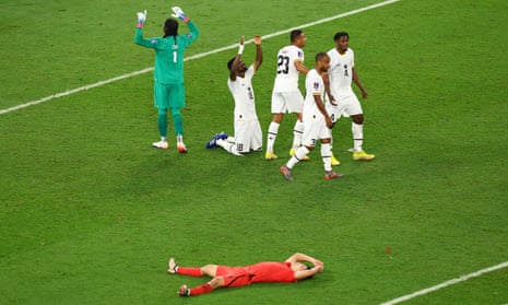 Ghana players celebrate after the match as South Korea's Jo Gue-sung looks dejected.
