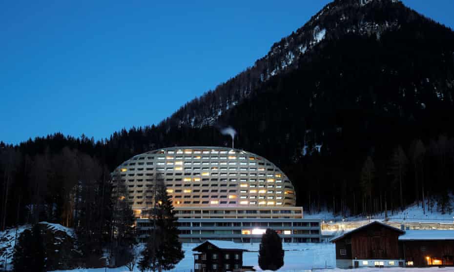 The Intercontinental Hotel is seen behind a farm house in Davos, Switzerland January 13, 2020. REUTERS/Arnd Wiegmann